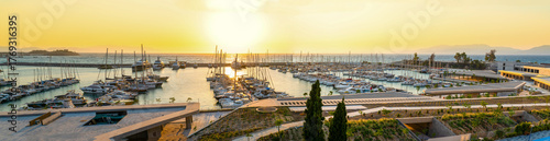 Kusadasi, Aydin, Turkey - August 27, 2025: Wide panoramic sunset view of the modern kusdasi marina filled with yachts and sailboats on the aegean coast