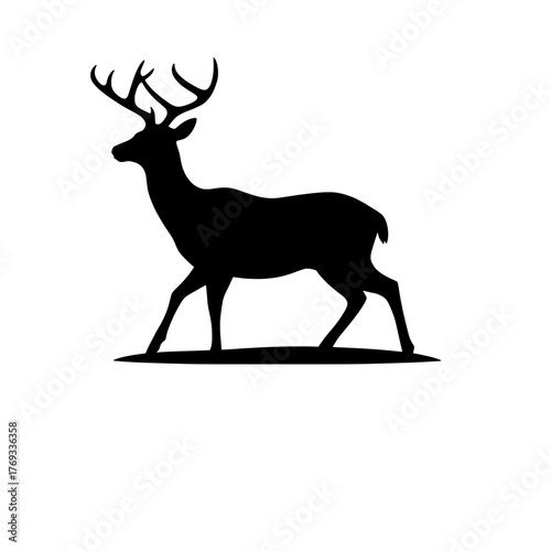 silhouette of a majestic stag with impressive antlers walking gracefully across a plain