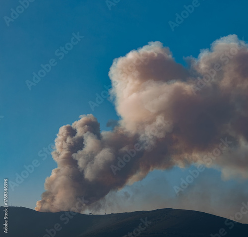Large Plume of Smoke Over Mountain Landscape
