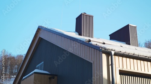 Wallpaper Mural Modern cottage building with panel facade and snowy roof under clear sky. Comfortable hotel waits for guests at winter countryside Torontodigital.ca