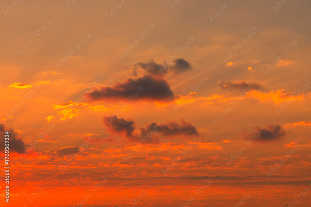 Fototapeta premium Sun rays at sunset with partly cloudy sky.