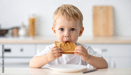 young child eating slice of peanut butter on toast for breakfast, allergen exposure theme