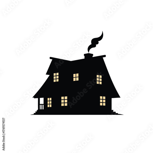 Silhouette of a haunted house with glowing windows and smoke