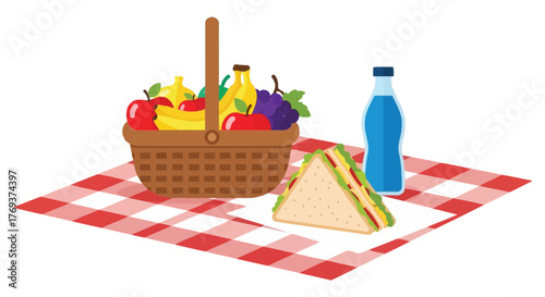 A picnic basket, a sandwich, and a drink are set out on a checkered blanket.