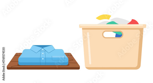 A neatly folded blue shirt sits beside a laundry basket filled with clothes.