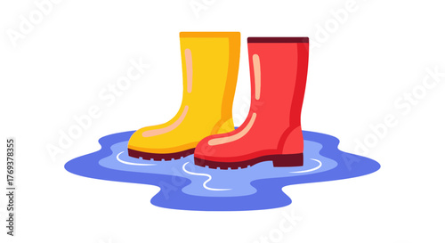 A pair of yellow and red rubber boots stand in a puddle of water.