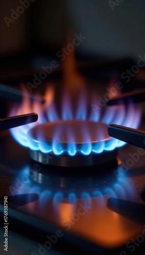 Close-up of propane gas burning intensely on kitchen stove, kitchenware, gas hob, burners