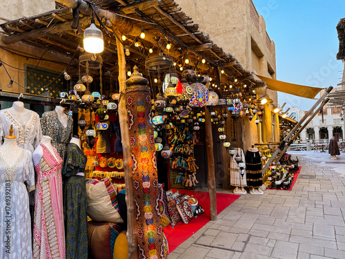 Old market street in Al Seef, Dubai with souvenir shops and traditional Arabic architecture. 