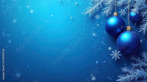 Blue Christmas ornaments on a frosted pine branch with snowflakes. Winter holiday decoration background with copy space