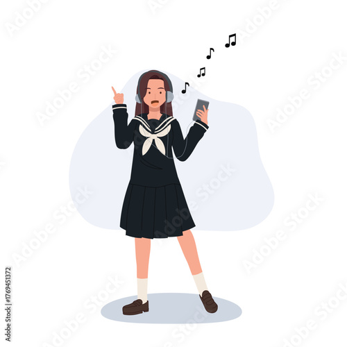 Japanese schoolgirl listening to music with headphones in school uniform. enjoying music on smartphone