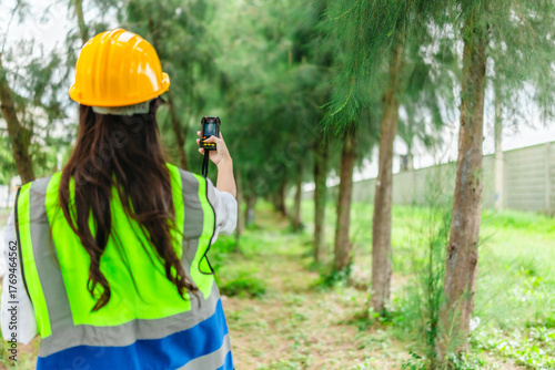 Female Environmental Surveyor Using GPS Land Meter in Forest