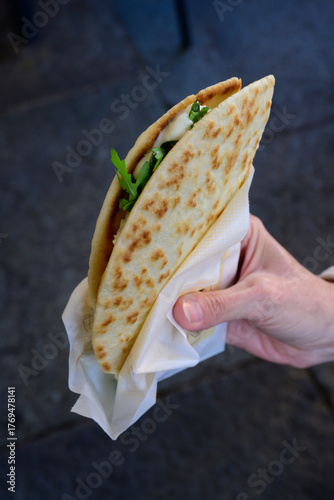 Piadina Romagnola Traditional Flatbread Sandwich Filled with Squacquerone Cheese and Arugula Street Food