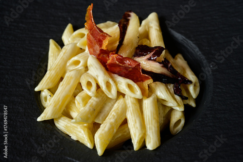 Penne al Gorgonzola Pasta with Creamy Blue Cheese Sauce garnished with Prosciutto Ham and Radicchio