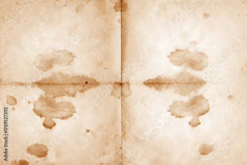 Stained Old Paper Texture Background. Old vintage paper folded in four. Brown crumpled and folded parchment vintage paper sheet with space for text