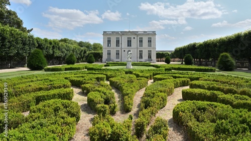 A view of a castle in central France with its topiary garden