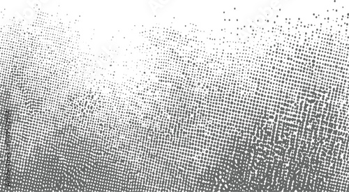 grayscale abstract pattern of dots fading from dense to sparse against white background.