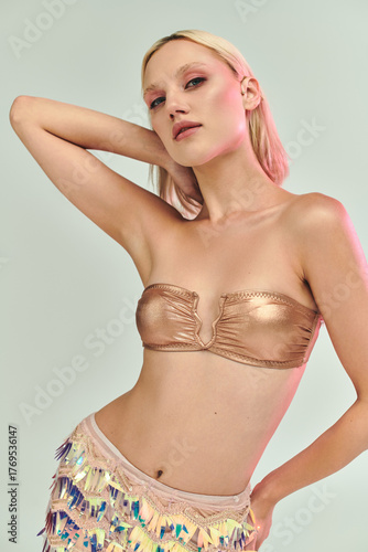 Wallpaper Mural Young woman in stylish party outfit with holographic details in vibrant studio setting Torontodigital.ca