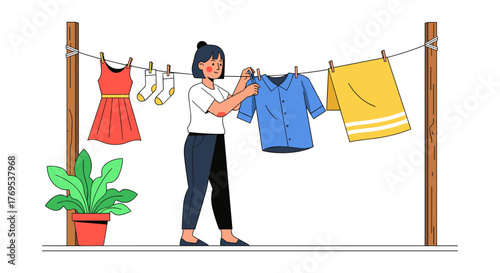 Woman hanging laundry outdoors with dress, shirt, and shorts on clothesline