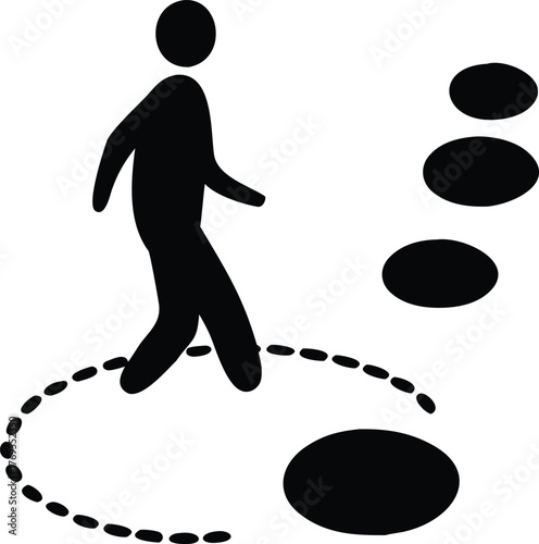 Silhouette of a person walking on a path of stepping stones