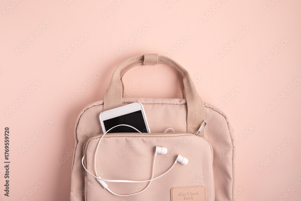 Naklejka premium Minimalist Pink Backpack with Smartphone and Earphones on Matching Background