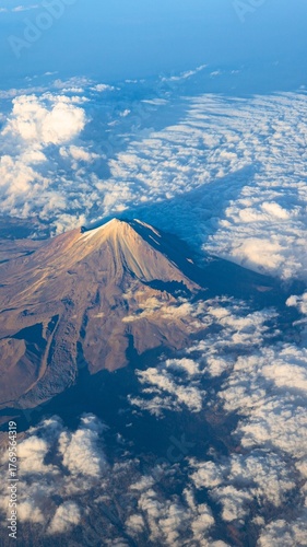 Bild auf Leinwand Majestic mount fuji peak peeking through fluffy clouds from above