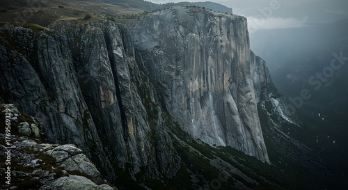 The sheer vertical drop of a mountain cliff.