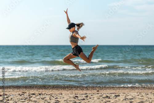 Energetic woman leaps at beach, Woman swiftly sprints and soars on sand, Woman rapidly runs and vaults with joy
