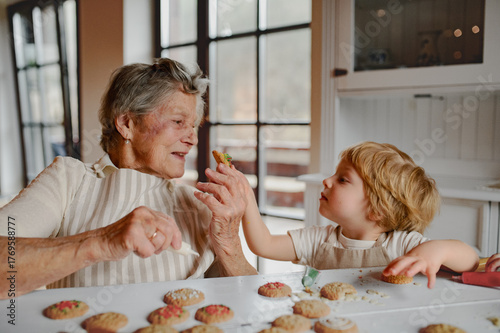 Family holiday baking with grandma in cozy kitchen.