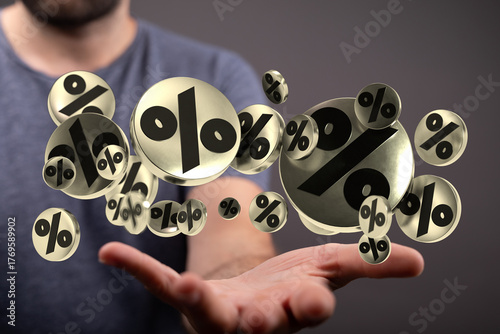 A person holding up many go...