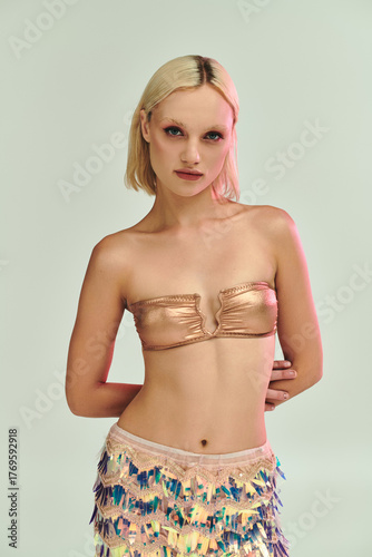 Wallpaper Mural Blonde young woman showcases stunning party outfit with holographic accents in studio Torontodigital.ca