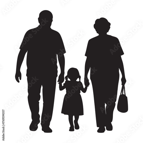 Silhouettes of a grandfather grandmother and granddaughter walking together holding hands