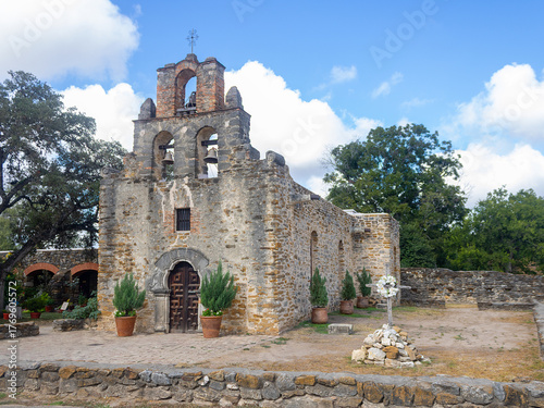 Historic Mission Espada in San Antonio, Texas — angled view of the front facade showcasing its Spanish colonial architecture. Established in 1690.