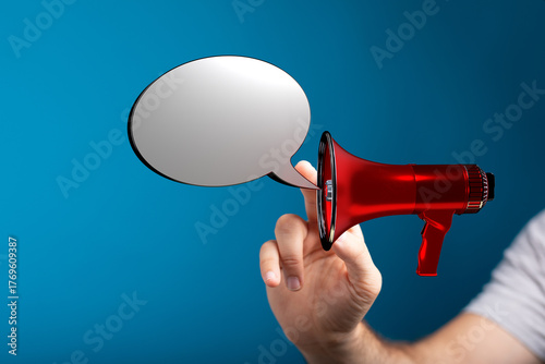 Hand holding a megaphone an...