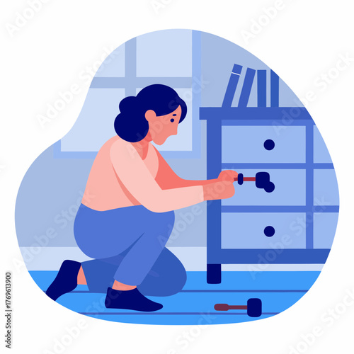 Woman attaching handles to a dresser while kneeling indoors  