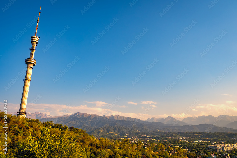 Obraz premium Scenic view of the Almaty Television Tower, the world's tallest free-standing tubular steel structure, on the slopes of Kok-Tobe in Almaty, Kazakhstan, with Altai Mountains in the background