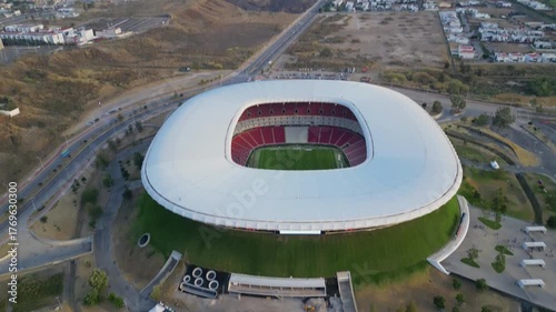 Aerial front pan revealing Akron Stadium's main entrance, architecture and dry surrounding area