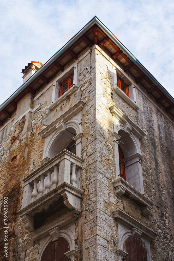 Fototapeta premium Old stone building facade with balcony detail