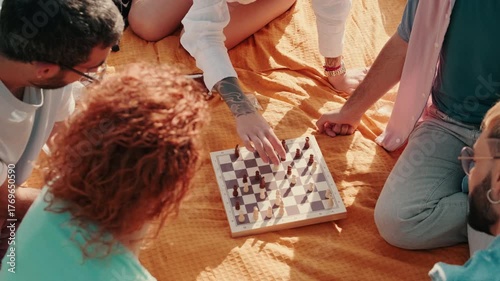 Friends Playing Chess at a Picnic