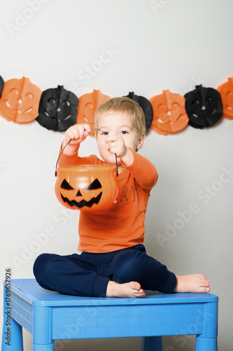 Cute Kids Celebrating Halloween with Pumpkin Buckets and Festive Emotions