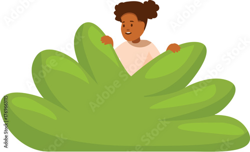 Little girl having fun playing hide and seek in the park, peeking over a bush