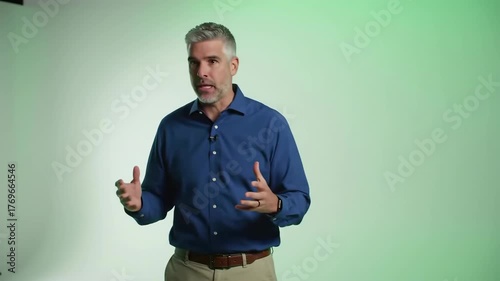 Man speaking with gestures against a gradient green background.