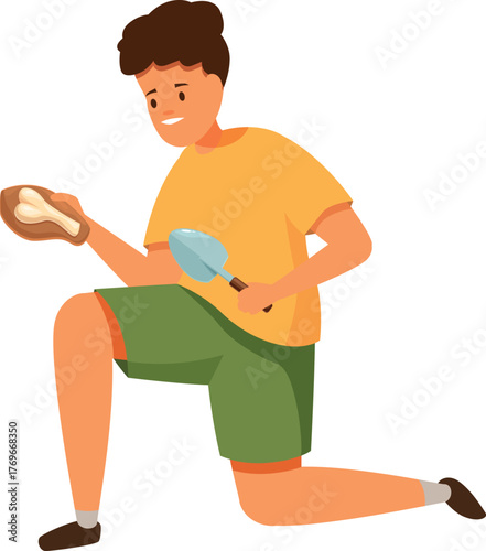 Boy paleontologist holding a trowel and examining a recently unearthed fossil on an excavation site