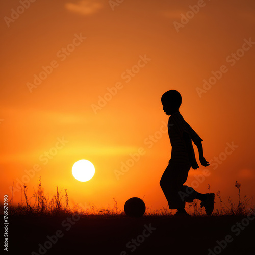 Focused Child Footballer: Silhouette of a Player in Action at Sunset.
