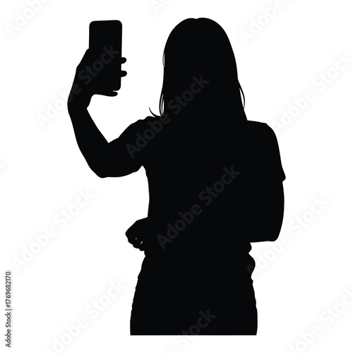 Silhouette of a woman taking a selfie with her smartphone camera silhouette