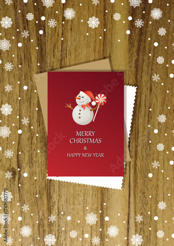 A wooden vertical surface decorated with Christmas decorations, a holiday card lies on the table, creating a warm festive atmosphere