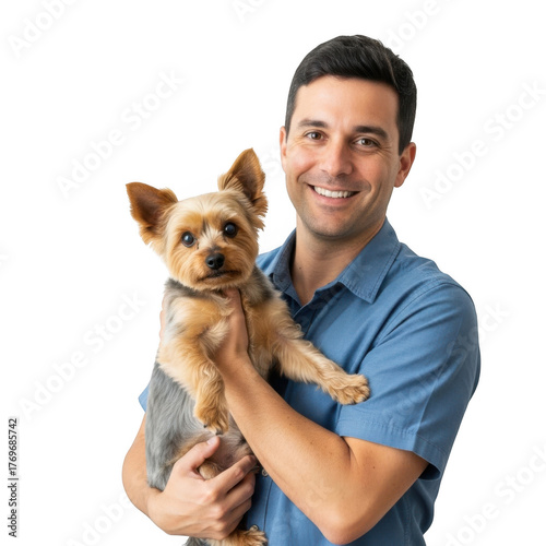 A smiling man in a blue collared shirt holds a small fluffy yorkshire terrier dog in his arms isolated on transparent background