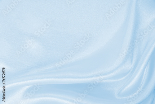 Smooth elegant blue silk or satin luxury cloth texture as abstract background. Luxurious background design
