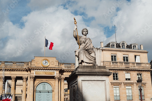 Paris, France - October 27, 2025: Statue La Loi de Jean -Jacques Feuchere with the National Assembly as background