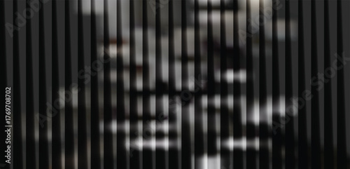 Monochromatic abstract pattern created by vertical blinds with dramatic light and shadow play, suggesting a modern, architectural aesthetic