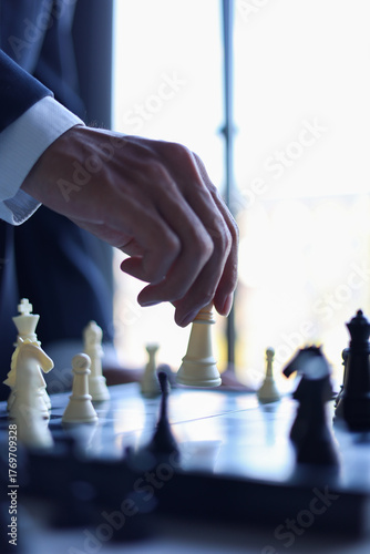 Businessman playing chess game; business strategy, leadership and management concept. Organize and manage projects efficiently using plan, task management, monitoring and collaborating to archive goal